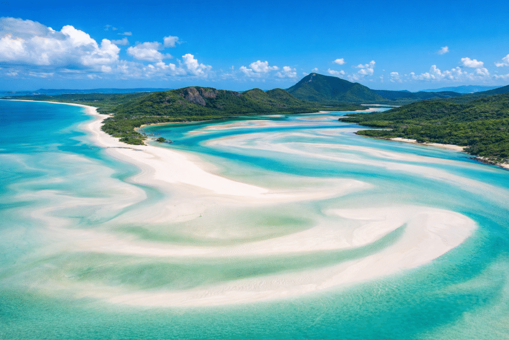 Aerial view of Whitehaven Beach in Australia with swirling white sand and turquoise water in the Whitsundays