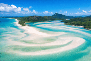 Aerial view of Whitehaven Beach in Australia with swirling white sand and turquoise water in the Whitsundays