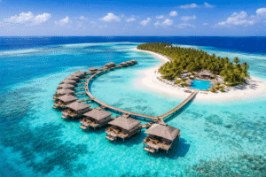 Aerial view of Maldives island with overwater villas and clear turquoise lagoon in tropical paradise